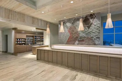 a wine tasting room with a stone wall at SpringHill Suites by Marriott Panama City Beach Beachfront in Panama City Beach