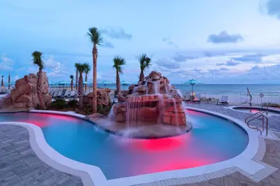 a pool with a fountain in front of the beach at SpringHill Suites by Marriott Panama City Beach Beachfront in Panama City Beach