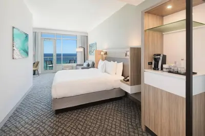 a hotel room with a bed and a view of the ocean at SpringHill Suites by Marriott Panama City Beach Beachfront in Panama City Beach