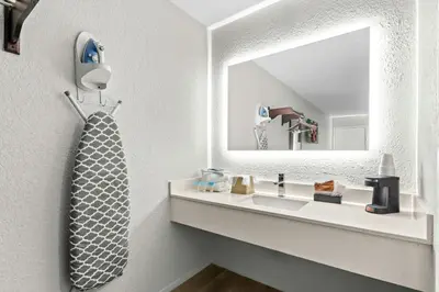 a bathroom with a sink and a mirror at Red Roof Inn Panama City Beach in Panama City Beach