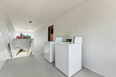 a kitchen with white appliances in a white wall at Red Roof Inn Panama City Beach in Panama City Beach