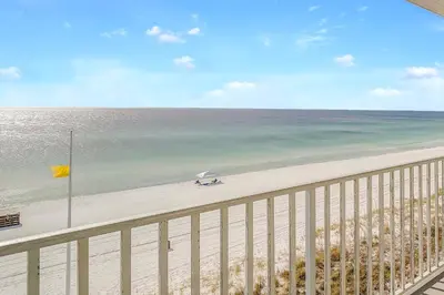 a view of a beach with an umbrella and the ocean at Sugar Sands Beachfront Hotel, a By The Sea Resort in Panama City Beach