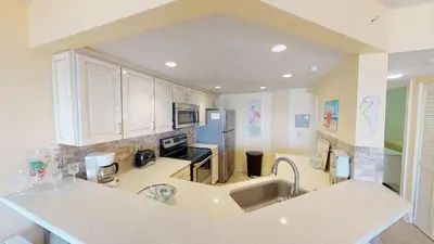 a kitchen with a sink and a counter top at Summer House 101 A in Panama City Beach