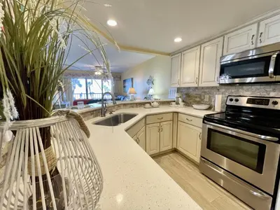 a kitchen with a sink and a stove top oven at Summer House 101 A in Panama City Beach