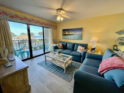 a living room with a couch and a table at Summer House 101 A in Panama City Beach