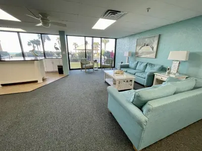 a living room with two couches and a table at Summer House 101 A in Panama City Beach