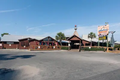 a restaurant with a building with a sign in front of it at The Reef At Seahaven Beach Resorts in Panama City Beach