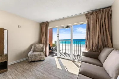 a living room with a view of the ocean at Seahaven Beach Hotel Panama City Beach in Panama City Beach