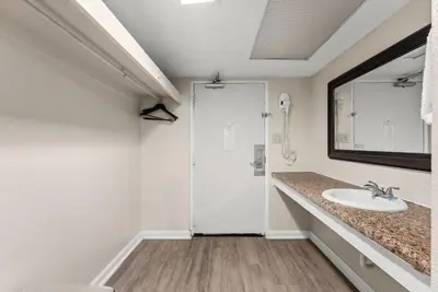 a bathroom with a sink and a mirror at Seahaven Beach Hotel Panama City Beach in Panama City Beach