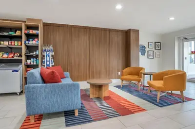a living room with two chairs and a table at Garner Hotel Panama City Beach Northeast by IHG in Panama City Beach