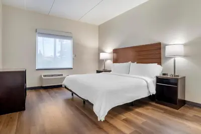 a bedroom with a large white bed and a window at Garner Hotel Panama City Beach Northeast by IHG in Panama City Beach