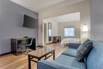 a living room with a couch and a table at Garner Hotel Panama City Beach Northeast by IHG in Panama City Beach