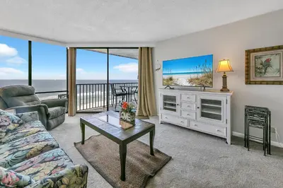 a living room with a couch and a table at Windward 604 at Edgewater in Panama City Beach