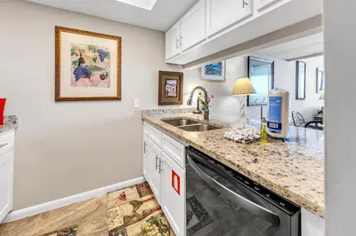 a kitchen with a sink and a dishwasher at Windward 604 at Edgewater in Panama City Beach