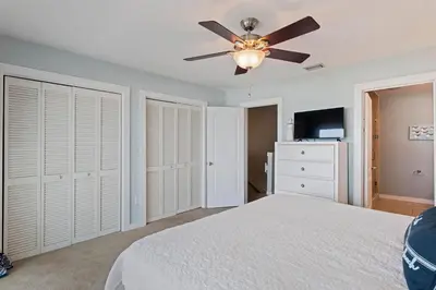 a bedroom with a bed and a ceiling fan at Walton Dunes 2 in Santa Rosa Beach