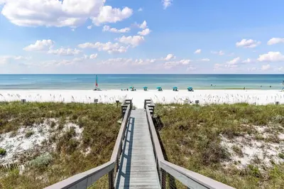 a boardwalk leading to the beach at a resort at Walton Dunes 2 in Santa Rosa Beach