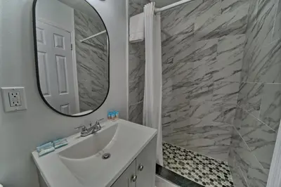 a bathroom with a white sink and a mirror at Aqua View Motel in Panama City Beach