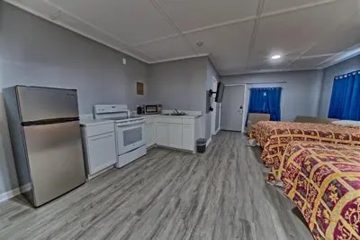 a hotel room with two beds and a kitchen at Aqua View Motel in Panama City Beach