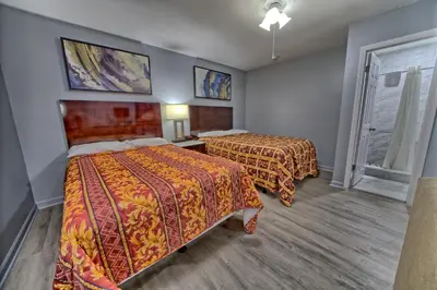 a hotel room with two beds and a window at Aqua View Motel in Panama City Beach