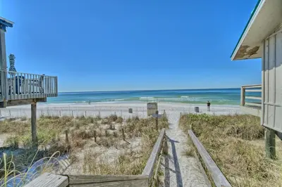 a view of the beach from the balcony of a beach house at Aqua View Motel in Panama City Beach