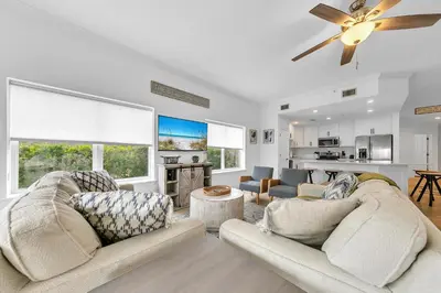 a living room with two couches and a ceiling fan at Legacy 104 in Santa Rosa Beach