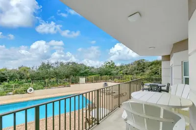 a balcony with a view of a swimming pool at Legacy 104 in Santa Rosa Beach