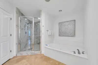 a white bathroom with a shower and a tub at Legacy 104 in Santa Rosa Beach