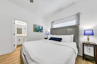 a white bedroom with a large bed and a window at Legacy 104 in Santa Rosa Beach