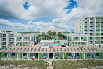 a large white building with a pool in front of it at Flamingo Hotel & Tower in Panama City Beach