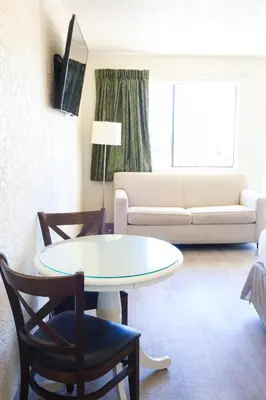 a living room with a table and a couch at Flamingo Hotel & Tower in Panama City Beach