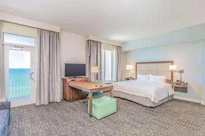 a hotel room with a bed and a television at Hampton Inn & Suites Panama City Beach-Beachfront in Panama City Beach