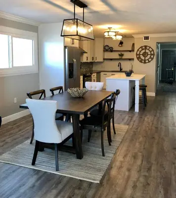 a dining room and kitchen with a table and chairs at Regency Towers - beachfront condo in Panama City Beach