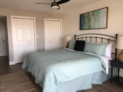 a bedroom with a bed and two white doors at Regency Towers - beachfront condo in Panama City Beach
