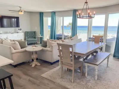 a living room with a table and a dining room at Long Beach Resort 204 in Panama City Beach