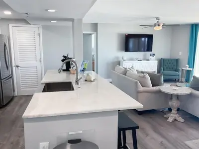 a kitchen and living room with a couch at Long Beach Resort 204 in Panama City Beach