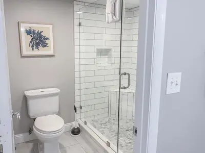 a bathroom with a toilet and a glass shower at Long Beach Resort 204 in Panama City Beach