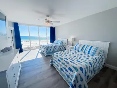 a bedroom with two beds and a view of the beach at Long Beach Resort 204 in Panama City Beach