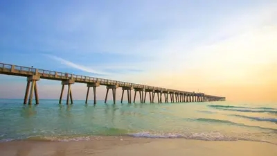 a pier stretches out into the ocean with a beach at Long Beach Resort 204 in Panama City Beach