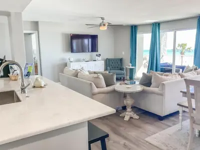 a kitchen and living room with couches and a table at Long Beach Resort 204 in Panama City Beach