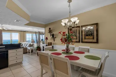 a kitchen and dining room with a table and chairs at Treasure Island 0202 in Panama City Beach