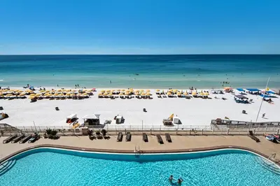 a view of a beach with umbrellas and the ocean at Treasure Island 0510 in Panama City Beach
