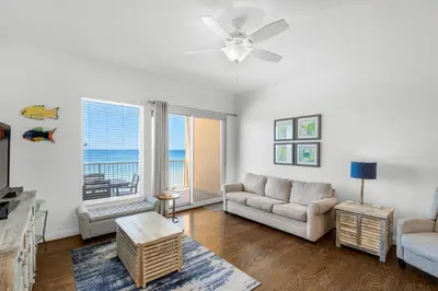 a living room with a couch and a ceiling fan at Treasure Island 0510 in Panama City Beach