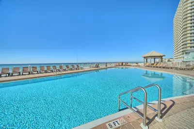a large swimming pool with the beach in the background at Treasure Island 0510 in Panama City Beach