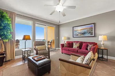 a living room with a red couch and chairs at Treasure Island 0602 in Panama City Beach