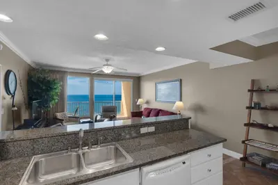 a kitchen with a sink and a view of the ocean at Treasure Island 0602 in Panama City Beach