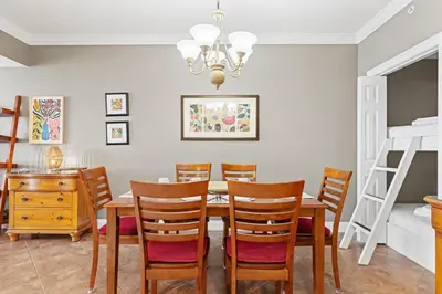 a dining room with a table and chairs at Treasure Island 0602 in Panama City Beach