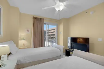 a hospital room with two beds and a flat screen tv at Treasure Island 0212 in Panama City Beach