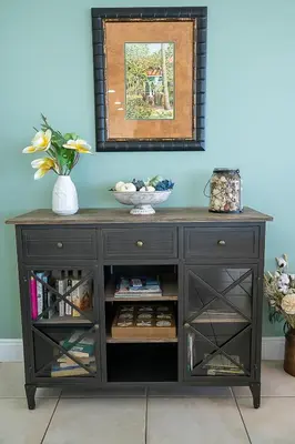a black wooden cabinet with open shelves in a room at Treasure Island 0212 in Panama City Beach