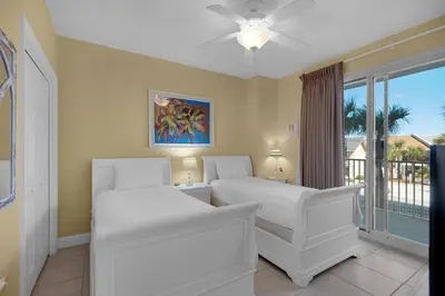 a bedroom with two white beds and a window at Treasure Island 0212 in Panama City Beach