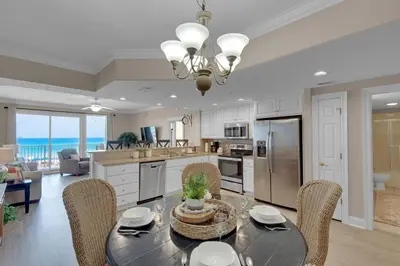 a kitchen and dining room with a table and chairs at Treasure Island 0211 in Panama City Beach